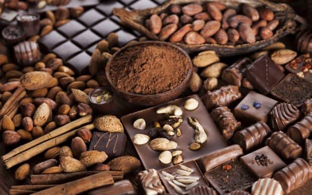 A variety of cocoa chocolates and nuts arranged with cocoa powder in the center, 2K Desktop Wallpaper
