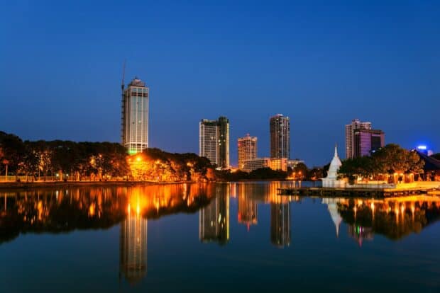 The Colombo Sri Lanka skyline reflects beautifully over calm water at dusk, HD Desktop Wallpaper
