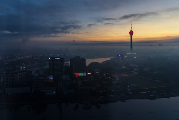 The Colombo city skyline with Lotus Tower glowing during sunset, HD Desktop Wallpaper