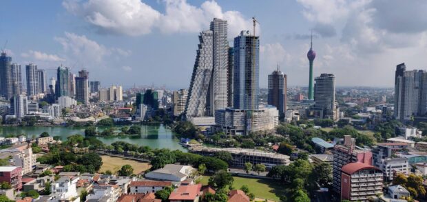 A clear view of Colombo Sri Lanka wallpapers featuring the skyline of the capital city with tall buildings and greenery, 2K Desktop Wallpaper