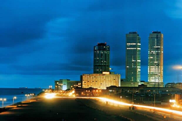 The Colombo Sri Lanka cityscape features illuminated buildings by the coast at night, HD Desktop Wallpaper