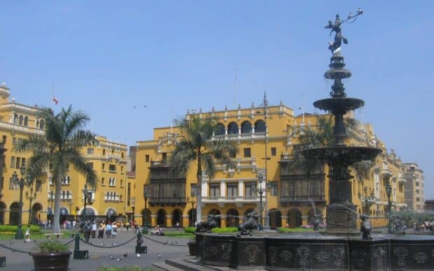 The city square in Peru features colonial yellow buildings and a large fountain, HD Desktop Wallpaper