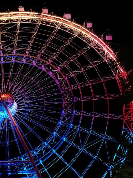 The Orlando Ferris wheel displays vibrant colorful lights at night, 2K Phone Wallpaper