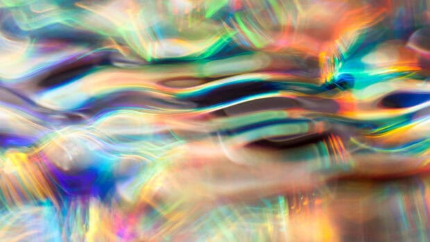 The image shows colorful abstract light waves in a holographic style, 2K Desktop Wallpaper