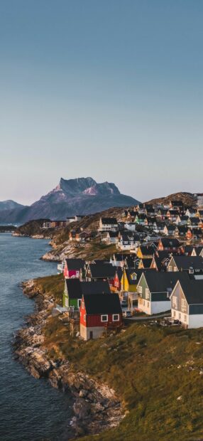 A scenic view of a colorful coastal village by the water with mountains in Norway, HD Phone Wallpaper