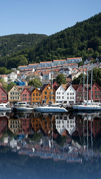 Colorful houses and boats reflect in calm water in a Norway town, HD Phone Wallpaper