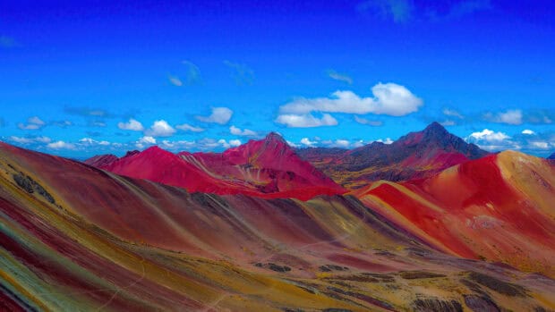 A vibrant view of the colorful mountains in Peru with blue skies and clouds, 4K Desktop Wallpaper