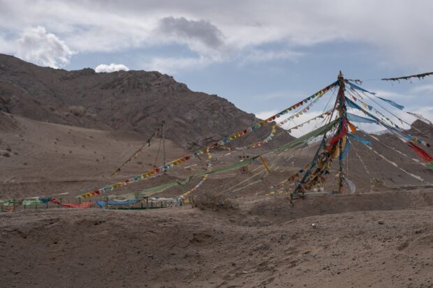 Colorful prayer flags stand against barren mountains in the Tibetan highlands, HD Desktop Wallpaper