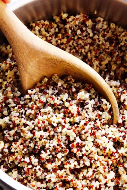 A close up of quinoa grains with a wooden spoon stirring in a bowl, HD Mobile Wallpaper
