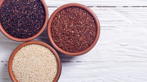Colorful quinoa seeds in clay bowls on a white wooden surface, HD Desktop Wallpaper