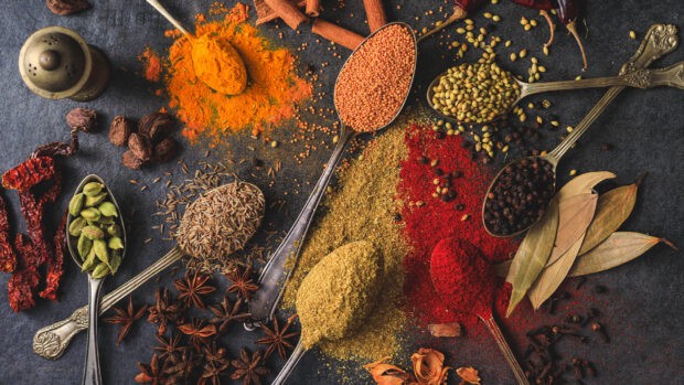 Various seasoning spices are displayed on spoons with vibrant colors and textures, HD Desktop Wallpaper