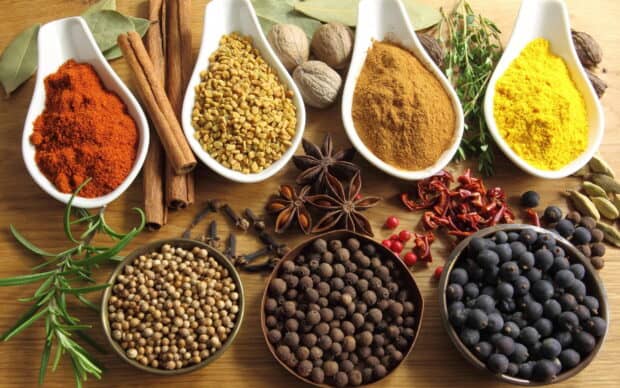 A close up of various seasoning wallpapers including cinnamon, pepper, and turmeric, 2K Desktop Wallpaper