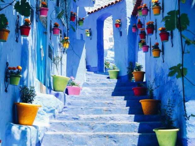 A vibrant street with colorful pots on blue walls in Morocco wallpapers, HD Desktop Wallpaper
