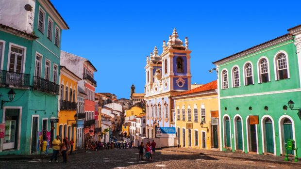 People walking on a colorful street in the Galapagos Islands with historic buildings and clear blue sky, HD Desktop Wallpaper