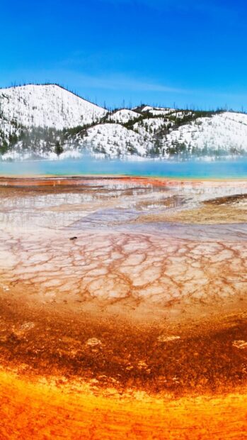 Vibrant Yellowstone National Park features steaming thermal pools and snow covered hills, HD Phone Wallpaper