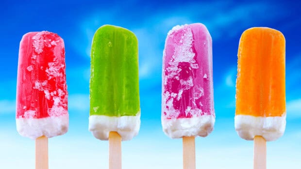 Four frozen popsicles show vibrant colors against blue sky, 4K Desktop Wallpaper