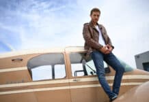 A confident man wearing a leather jacket stands next to a small private plane, The Bachelor Tv Series Wallpapers, 2K Desktop Wallpaper