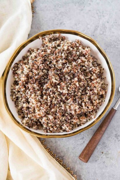 A bowl filled with cooked quinoa showing its texture and mixed colors, HD Mobile Wallpaper