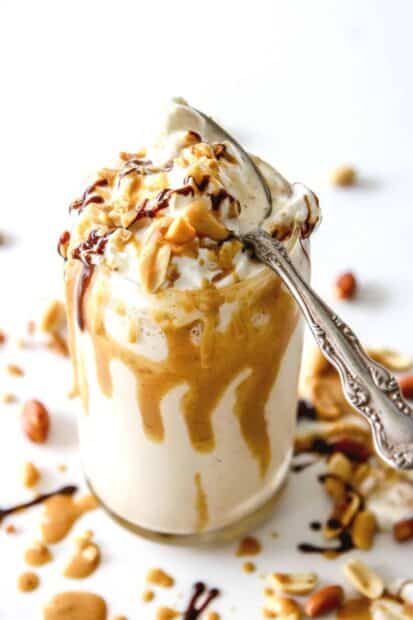 A creamy peanut butter milkshake topped with whipped cream, nuts, and chocolate sauce, HD Mobile Wallpaper