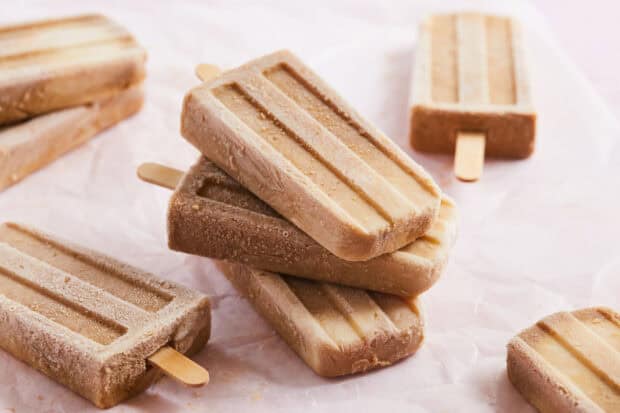 A close up of creamy popsicles stacked on parchment paper with a smooth texture, HD Desktop Wallpaper