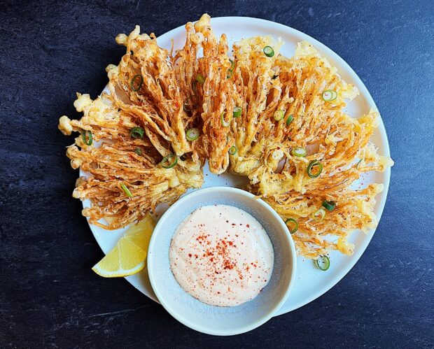 Crispy fried enoki mushrooms are served on a white plate with lemon wedges and creamy sauce, 2K Desktop Wallpaper