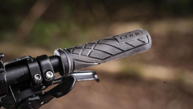 A close up of a black Cube Bikes handlebar grip with the logo visible, HD Desktop Wallpaper