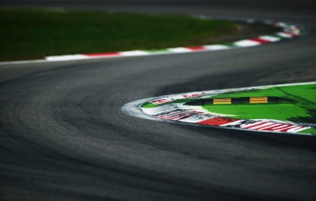 A close up view of a curved section on a race track with painted edges and tire marks, HD Desktop Wallpaper