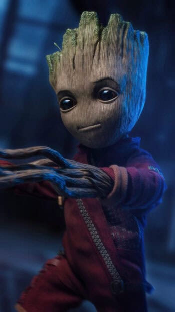 A detailed shot of Groot wearing a red outfit stretching his wooden arms, 4K Phone Wallpaper
