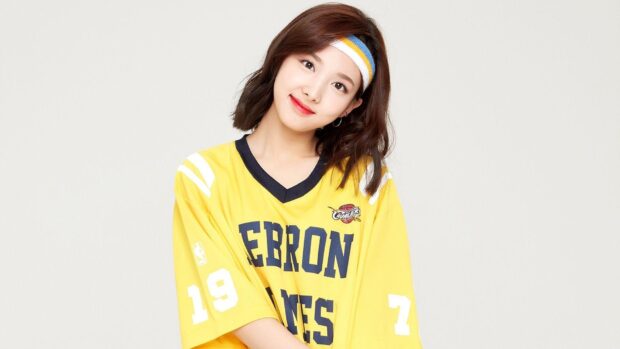 A smiling Nayeon poses wearing a yellow sports jersey and a headband in this Nayeon Wallpapers, HD Desktop Wallpaper
