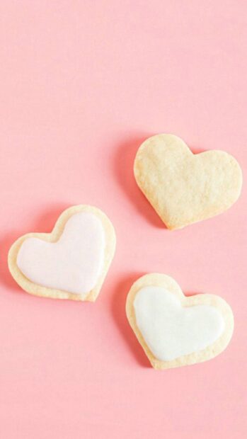 Three heart shape cookies with icing are placed on a pink background, HD Mobile Wallpaper