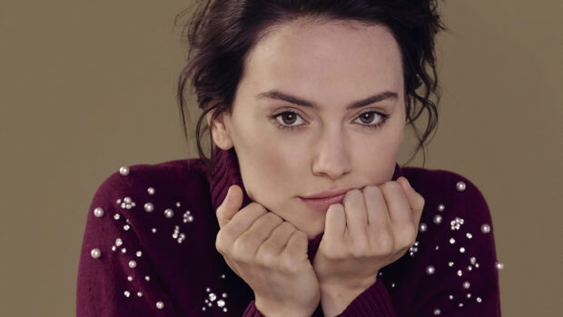 A close up portrait of Daisy Ridley wearing a purple sweater with pearl embellishments, 4K Desktop Wallpaper