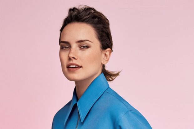 Daisy Ridley is wearing a blue shirt against a pink background, HD Mobile Wallpaper