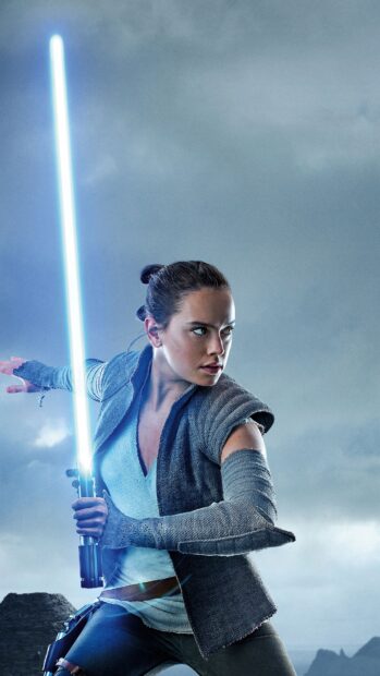 Daisy Ridley holds a glowing lightsaber ready for battle under a cloudy sky, 4K Phone Wallpaper