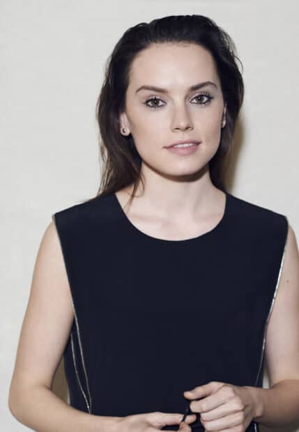 Daisy Ridley looks directly at the camera wearing a black sleeveless top and holding an object, 2K Mobile Wallpaper