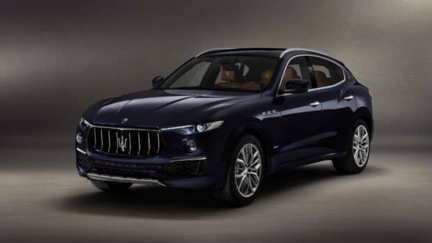 A dark blue Maserati Levante is shown in a studio setting highlighting its design and grille, 4K Desktop Wallpaper
