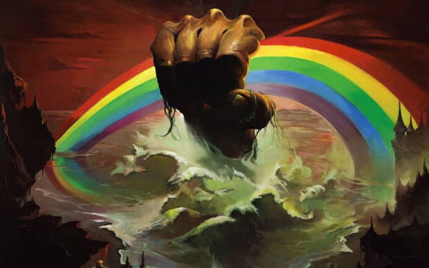 A dark fist emerges from turbulent sea under a vibrant rainbow in a surreal scene with rocky cliffs, HD Desktop Wallpaper