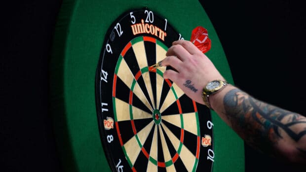 A hand with tattoos placing darts on a darts board during a game, HD Desktop Wallpaper