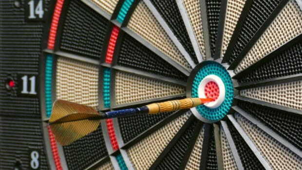 A dart hits the bullseye on a textured dartboard in a close up view of darts wallpapers, 4K Desktop Wallpaper