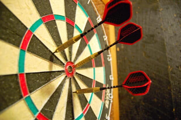 Three darts hit the bullseye on the dartboard in the darts wallpapers, 2K Desktop Wallpaper