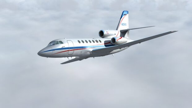 A Dassault Falcon 50 jet flying above the clouds in clear skies, HD Desktop Wallpaper