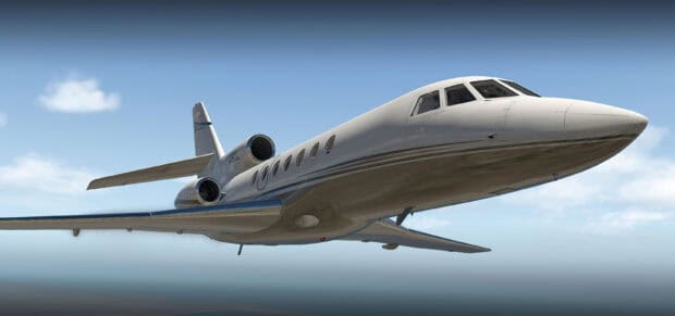 A Dassault Falcon 50 jet flying above the clouds in a clear blue sky, 2K Desktop Wallpaper