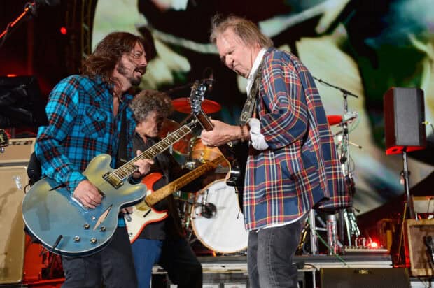 Dave Grohl is playing guitar on stage with a fellow musician during a live concert, HD Desktop Wallpaper