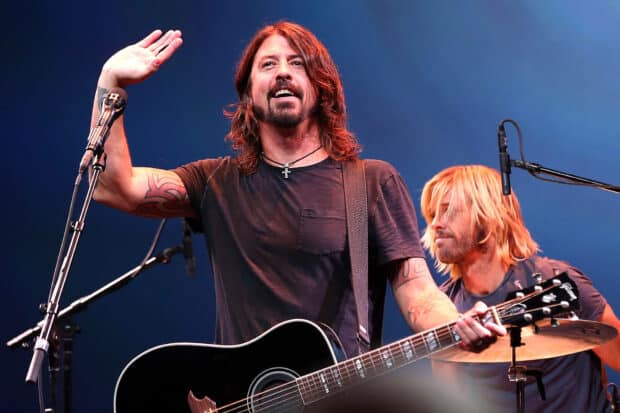 Dave Grohl performing on stage with a guitar and another musician playing drums, HD Desktop Wallpaper