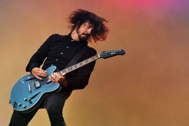 Dave Grohl playing electric guitar on stage during a concert, HD Desktop Wallpaper