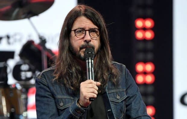 Dave Grohl is holding a microphone during a live event, HD Desktop Wallpaper