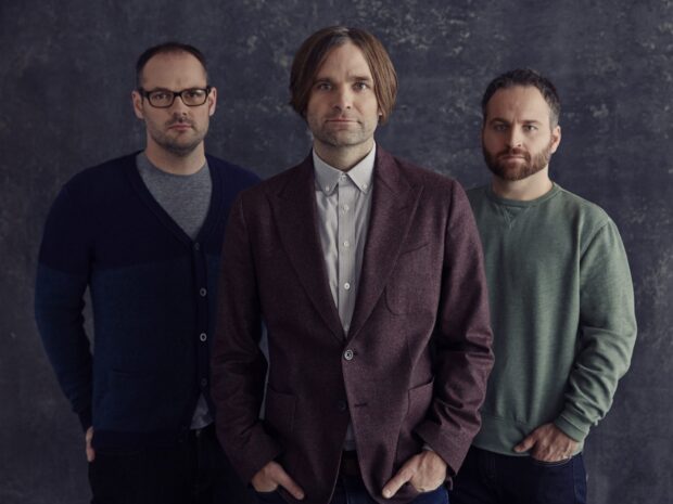 The members of Death Cab For Cutie pose together against a textured gray background, HD Desktop Wallpaper