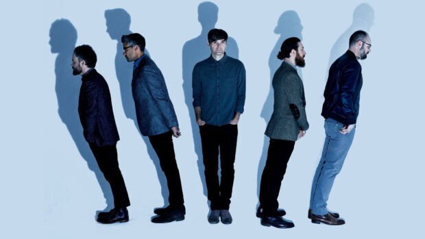 The Death Cab For Cutie band members stand against a light blue background casting large shadows, HD Desktop Wallpaper