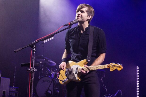 A musician of Death Cab For Cutie plays guitar during a concert on stage, HD Desktop Wallpaper