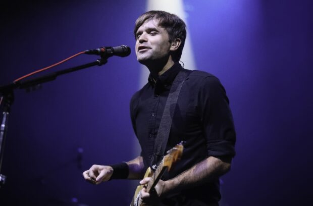 A lead singer plays guitar and sings for Death Cab For Cutie during a concert, HD Desktop Wallpaper
