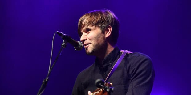 A member of Death Cab For Cutie sings and plays guitar on stage, HD Desktop Wallpaper